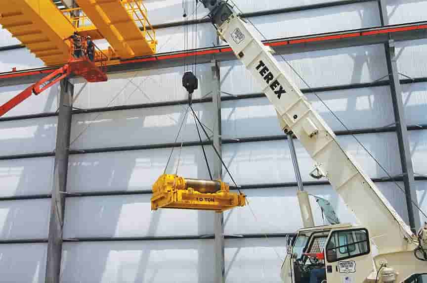 article-custom-built-up-hoist-vs-package-hoist-systems-raising-hoist-into-place