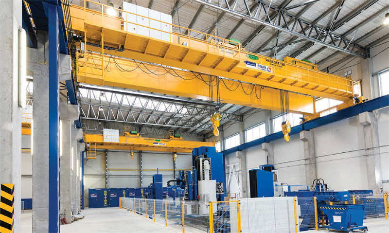 Double-girder overhead travelling cranes at work in the factory building of VVE, a Slovakian manufacturer of hydroelectric power plants.