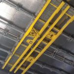 The yellow equipment shown is the Main Cranes System and TensileTruss, built by PaR Systems. This photo was taken from the ground, looking up at the roof of the New Safe Confinement arch
