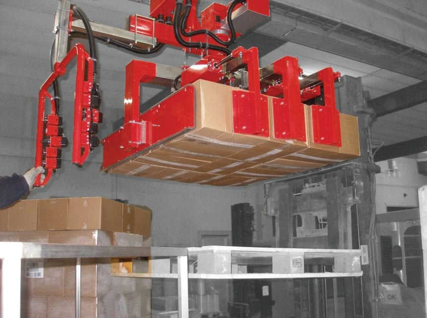 Dalmec pinch jaws gripping system for cardboard boxes stacked in layers. The tooling applied to the Partner Equo industrial manipulator handles complete layers, composed of 12 boxes up to 2m height.