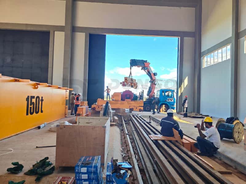 Workers are installing tracks on the steel structure